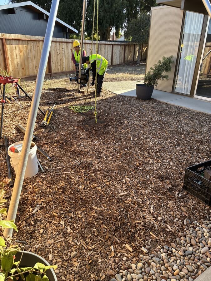 Field crew drilling a boring beside a home in Foster City for an addition